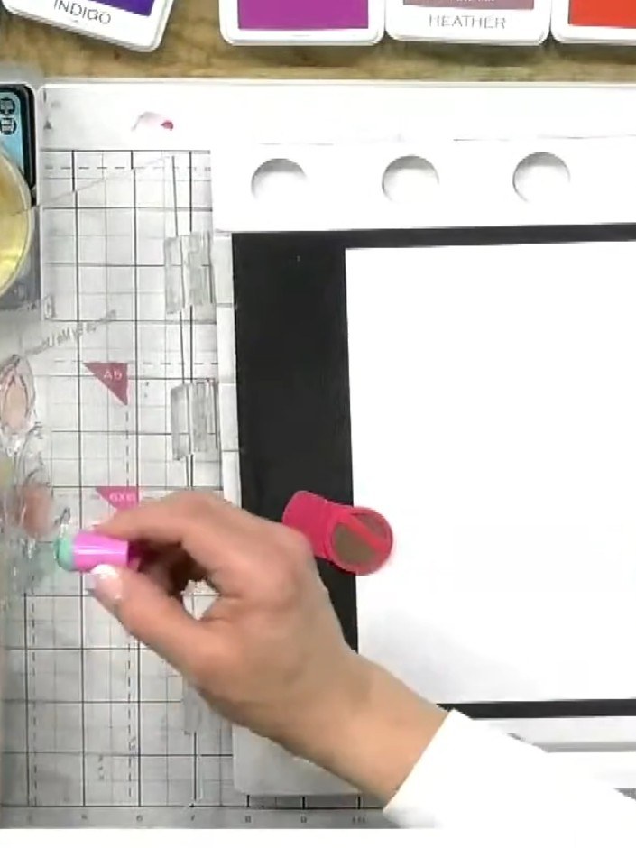 Step 6: Line up the fine detail tulip stamp and stamp it in black ink directly over the coloured base layer to complet