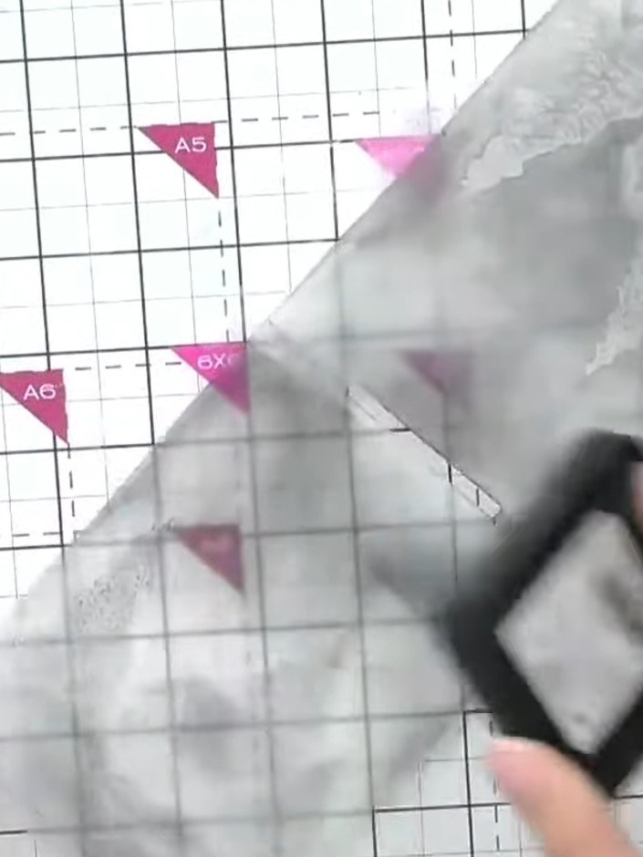 Step 2: Place your patterned paper with trees or winter imagery into the inked embossing folder. Position the paper ca