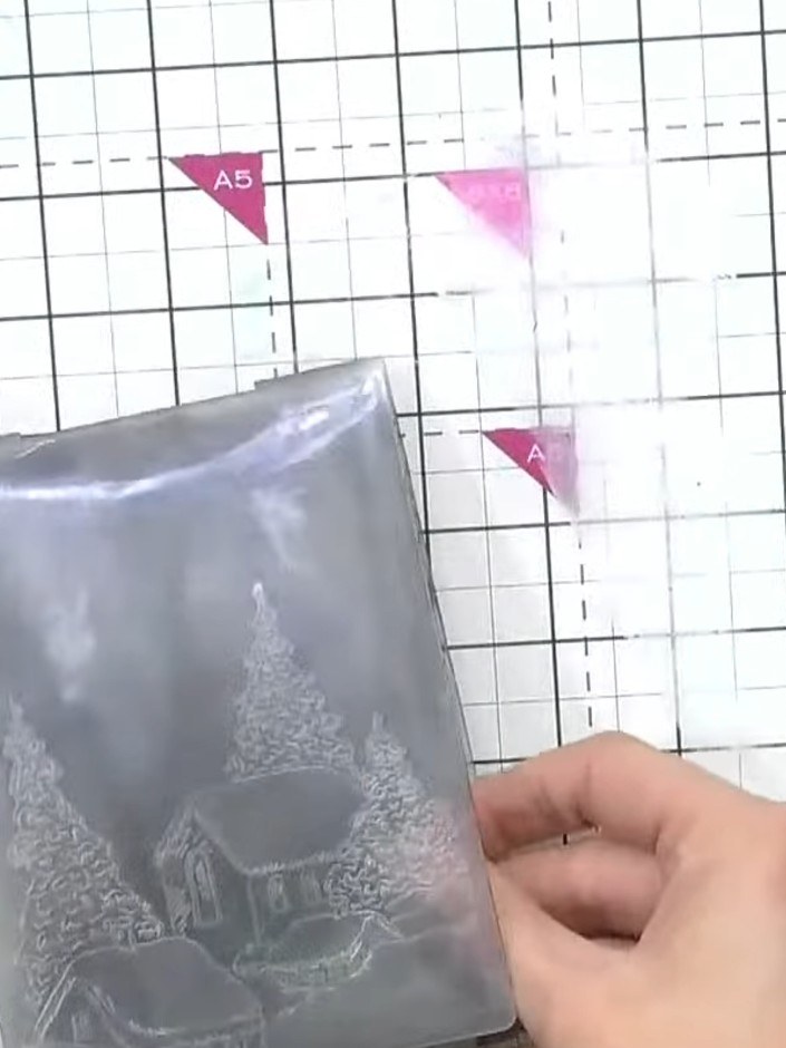 Step 4: Examine the embossed result. You should see the skeleton trees and snowflake details from the pattern showing 