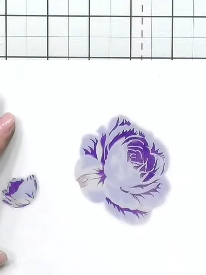 Step 8: Apply purple ink to the stamped rose images using an ink pad, blending the colour over the entire design to cr