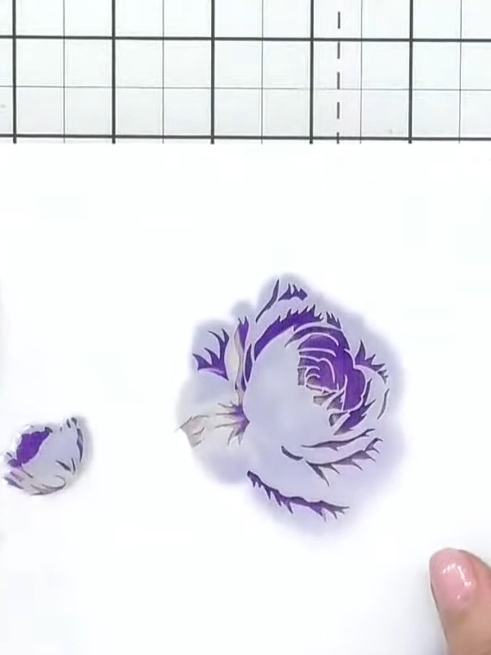 Step 9: Carefully peel away the final stencil to reveal your completed three-dimensional purple rose with detailed pet