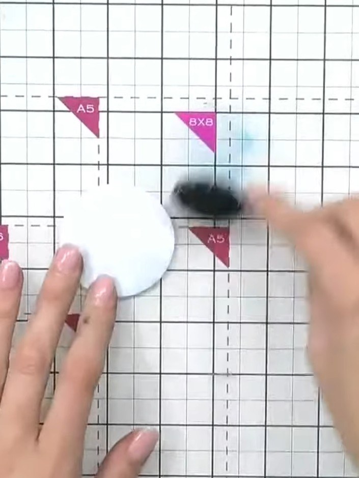 Step 2: Using a brush, apply light teal ink all over the white circle to create an even base colour.