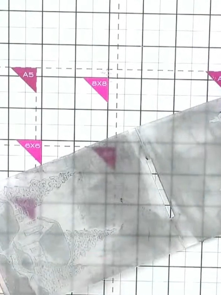 Step 2: Place your white card stock into the embossing folder, ensuring it is positioned centrally within the folder.