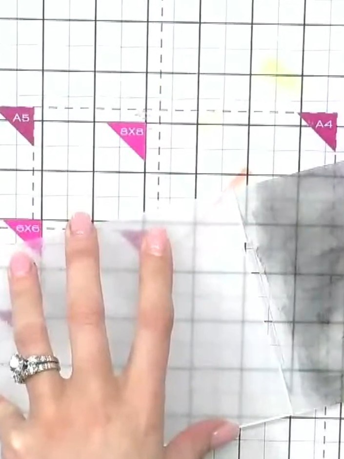 Step 4: Place your inked card face-up on the cutting mat with the embossing folder positioned over it. Run the card th