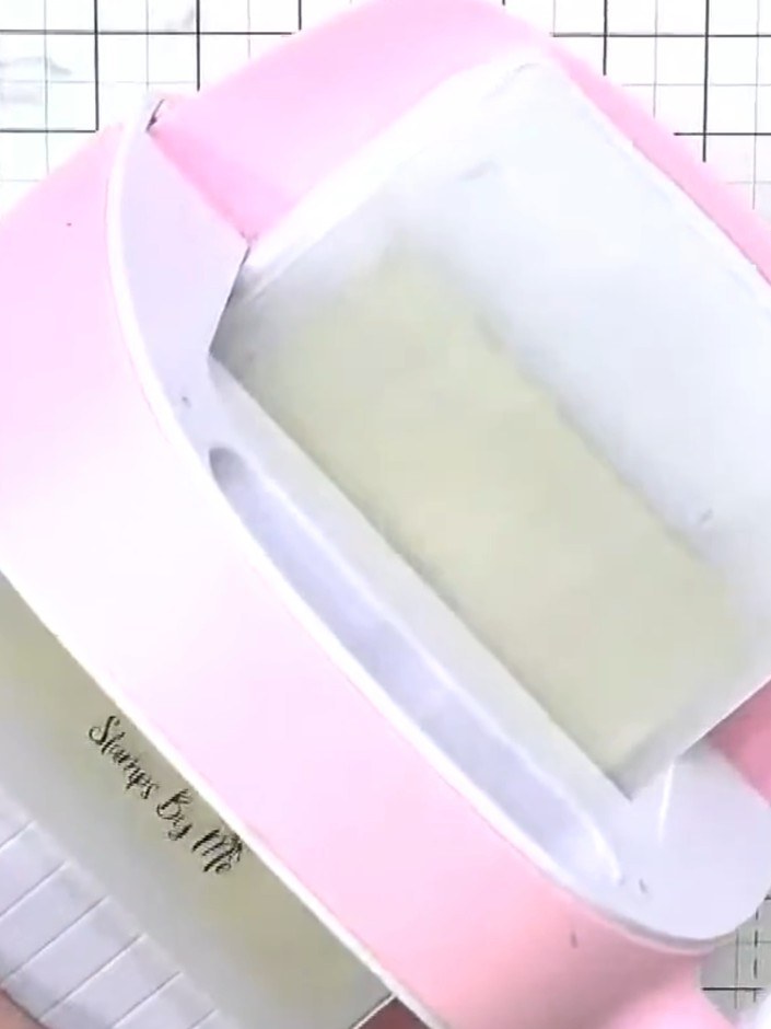 Step 3: Place your gold card stock into the embossing folder. Position the card stock centrally within the folder, ens