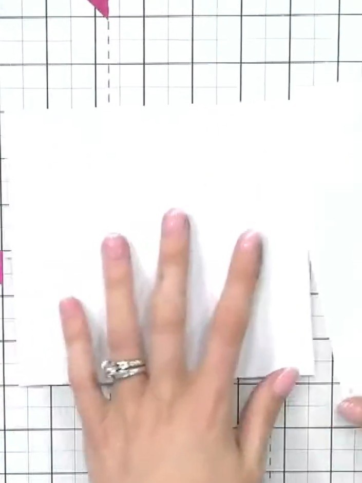 Step 1: Prepare your white card stock and position the rose branch layering stencil system on top. Use the four corner