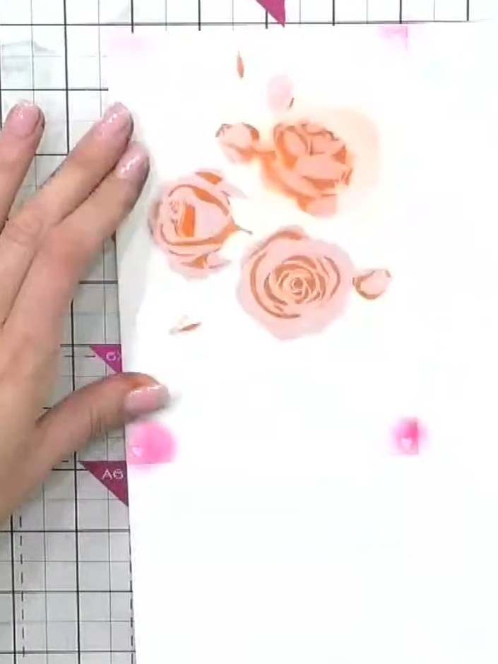 Step 7: Apply stencil number five using green ink to add foliage details to your layered rose design. Position the ste