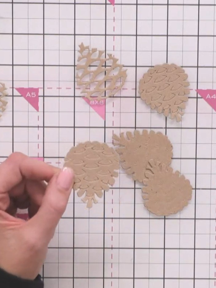 Step 4: Apply glue randomly to the back of the first pine cone layer. Avoid precise placement for a natural look.