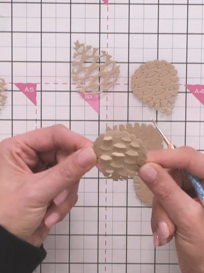 Step 6: Turn the pine cone piece over and use a pokey tool to push the embossed flaps through to the front, creating a