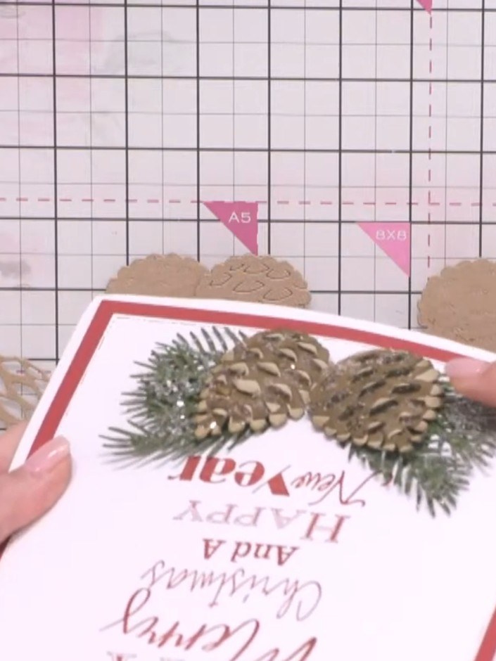 Step 9: Adhere the second pine cone layer to the base layer on the card, allowing the edges to sit slightly unevenly f