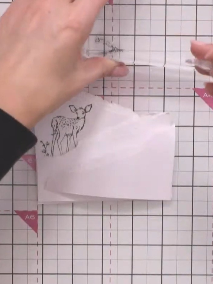 Step 3: Stamp the laying-down deer image in black ink on the lower portion of the card front to create a second focal 