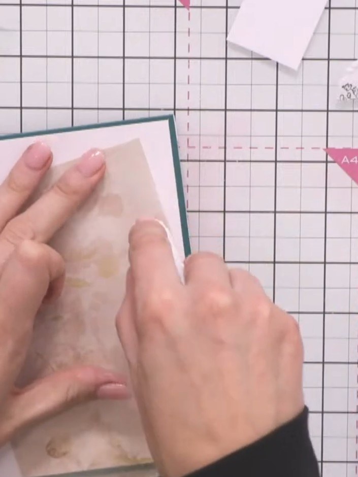Step 7: Adhere the vellum layer to the card front using a tape pen. Apply adhesive in random places around the edges a