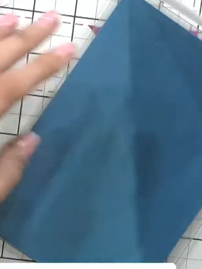 Step 4: Place your blue cardstock inside the embossing folder and run it through your embossing machine to create the 