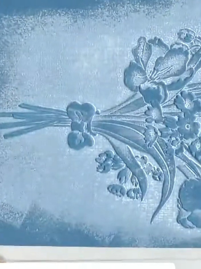 Step 1: Select a smooth black cardstock for your project. Choose your embossing folder with the desired floral design.