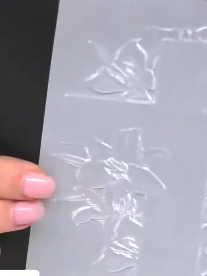 Step 2: Ink both sides of the embossing folder with a black or dark ink pad. Ensure the entire surface is covered with