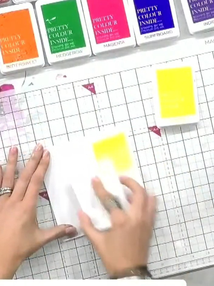 Step 2: Using various coloured ink pads (yellow, orange, purple, blue), dab spots of colour randomly across the white 