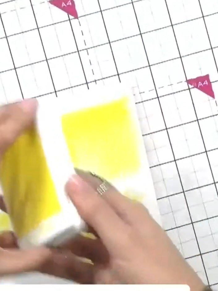 Step 3: Working over a spray box, apply yellow mica spray over the coloured ink pads to create a shimmering effect and
