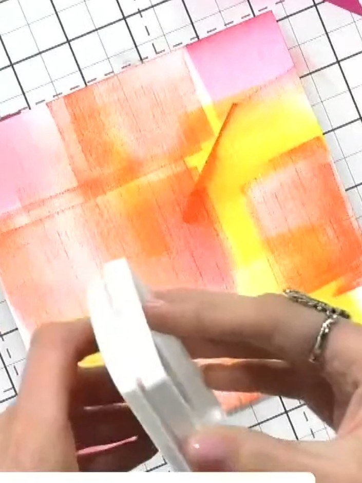 Step 6: Place the dried, sprayed cardstock into the inked embossing folder, ensuring it is positioned centrally within