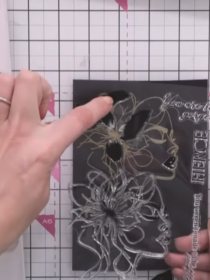 Step 1: Line up the first lamination stamp by matching the lips on the stamp to the lips on the embossed lady image.