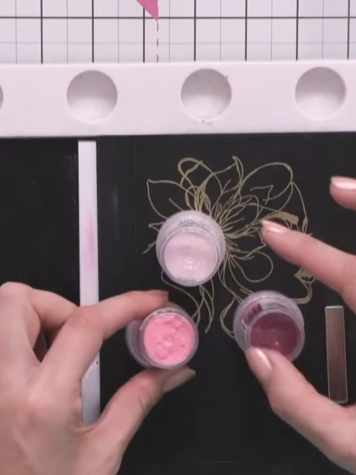 Step 3: Apply the dark fuchsia embossing powder (Bibbidi Bobbidi Boo) over the gold embossed image on the black card. 