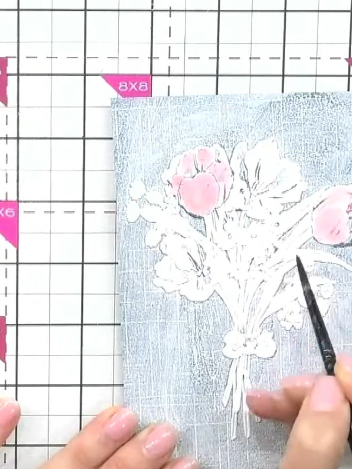 Step 2: Using a paintbrush, apply pink watercolour or ink to the wet embossed panel, working over the raised floral de
