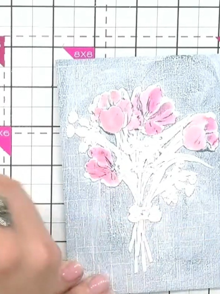 Step 4: Insert the coloured cardstock with the pink flowers into your embossing folder. Ensure the design is properly 