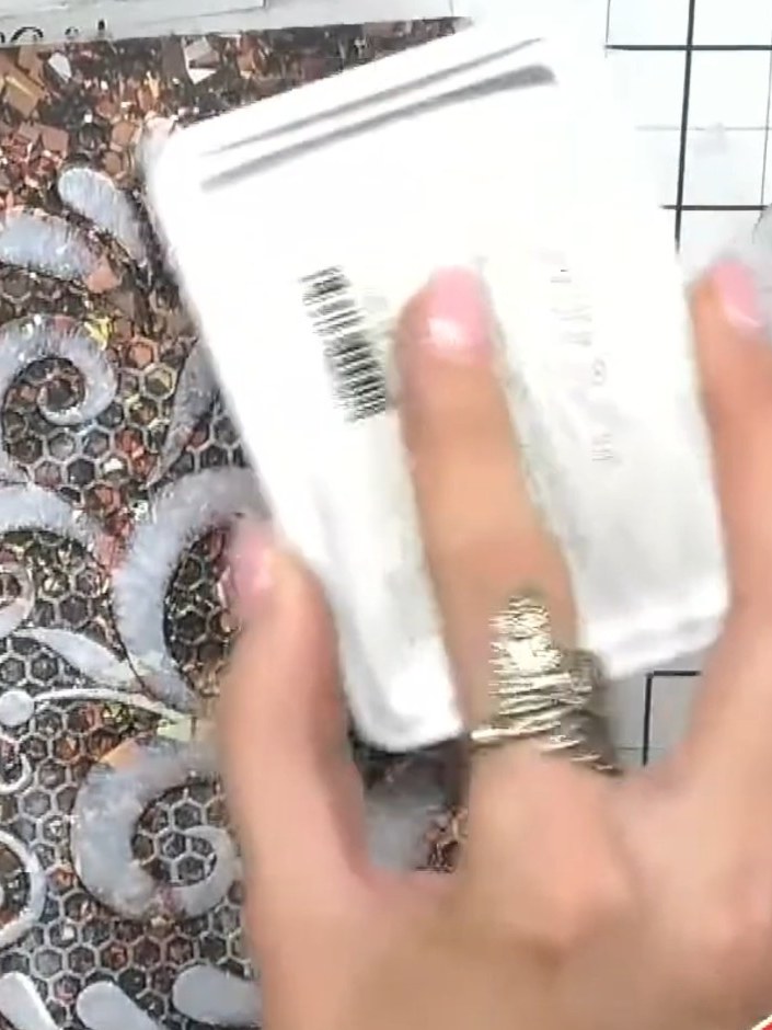 Step 2: Load your white ink pad with colour by dabbing it onto the embossed card. Pick up the bronze, copper and metal