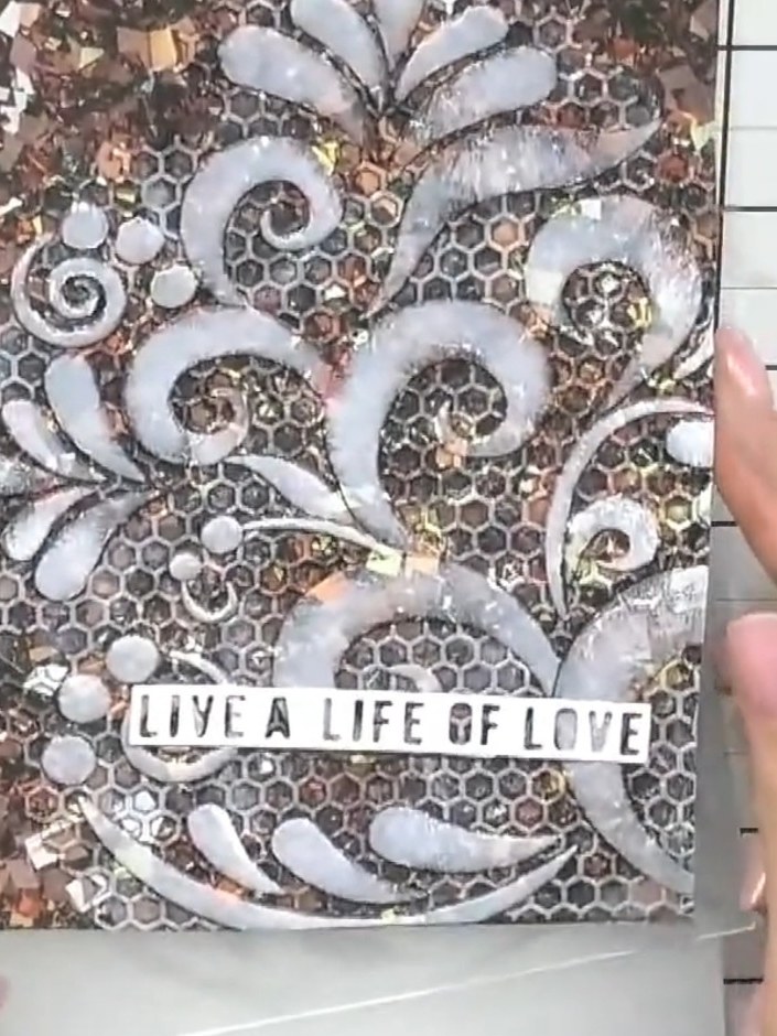 Step 4: Use the corner of a white ink pad to work the ink into the fine details and crevices of the embossed design. T
