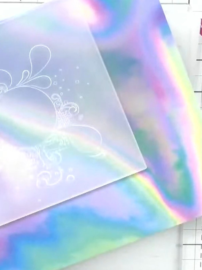 Step 2: Place your stamped holographic paper into the embossing folder with the 'HD 3D' design, ensuring the white sta