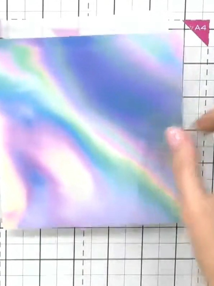 Step 4: Remove the holographic paper from the embossing folder and examine the raised design. The pattern should show 