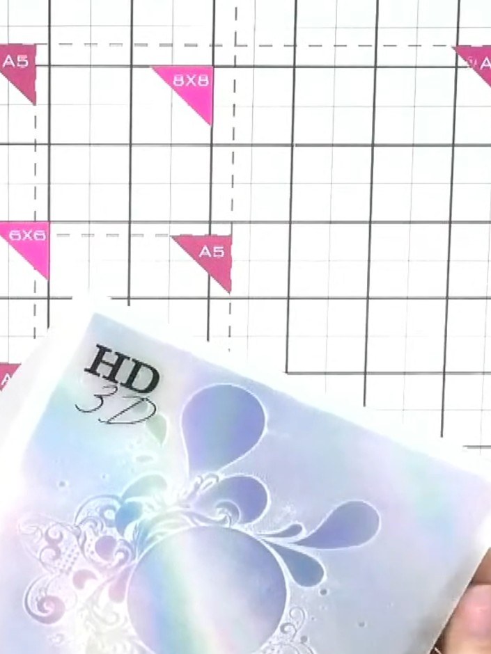 Step 6: Using a light touch with the white embossing folder, gently press onto the holographic paper to create a subtl