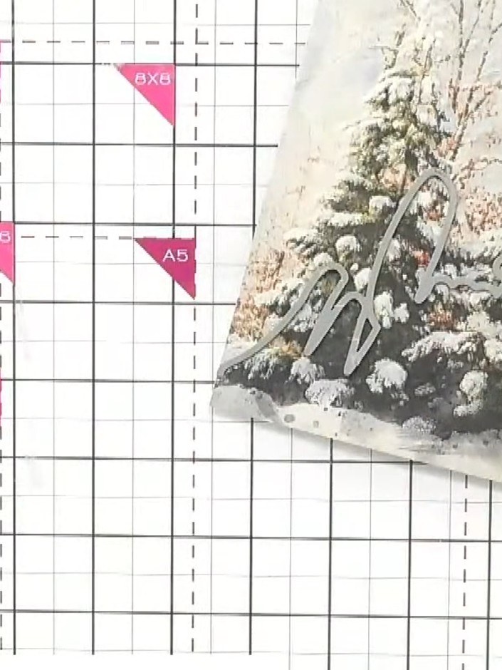 Step 3: Position and adhere the first snow drift word cut-out to the top of your card base, aligning it with the winte