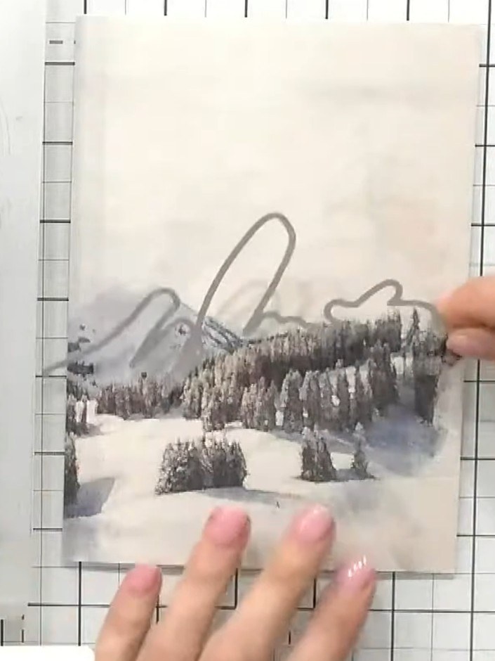 Step 7: Apply white ink to the base of the card using a blending tool or sponge to create a wintry, sparkly effect at 
