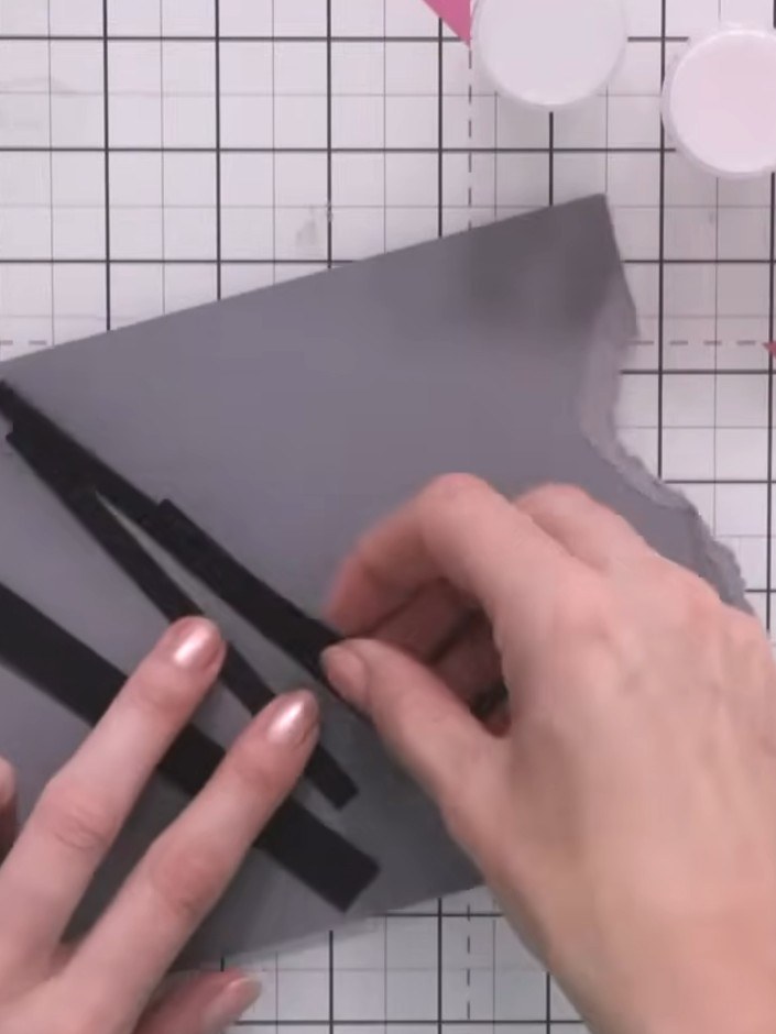 Step 1: Cut several strips of varying widths from the black cardstock using a guillotine or paper trimmer.