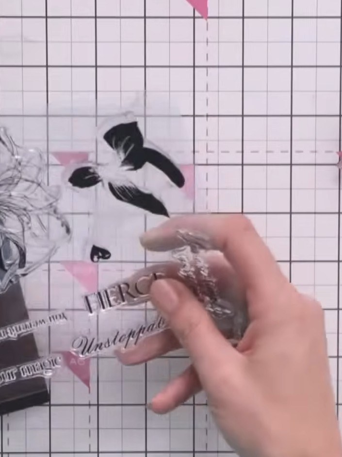 Step 7: Stamp a sentiment word such as 'Fierce' onto a long thin strip of card using gold embossing powder. Heat embos
