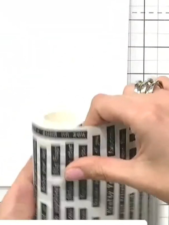 Step 1: Position your washi tape roll on your card stock or acetate. Apply the tape smoothly, ensuring you don't get a