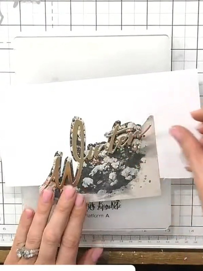 Step 4: Position the painted mount over your chosen festive image on a piece of card stock. Ensure the image shows thr