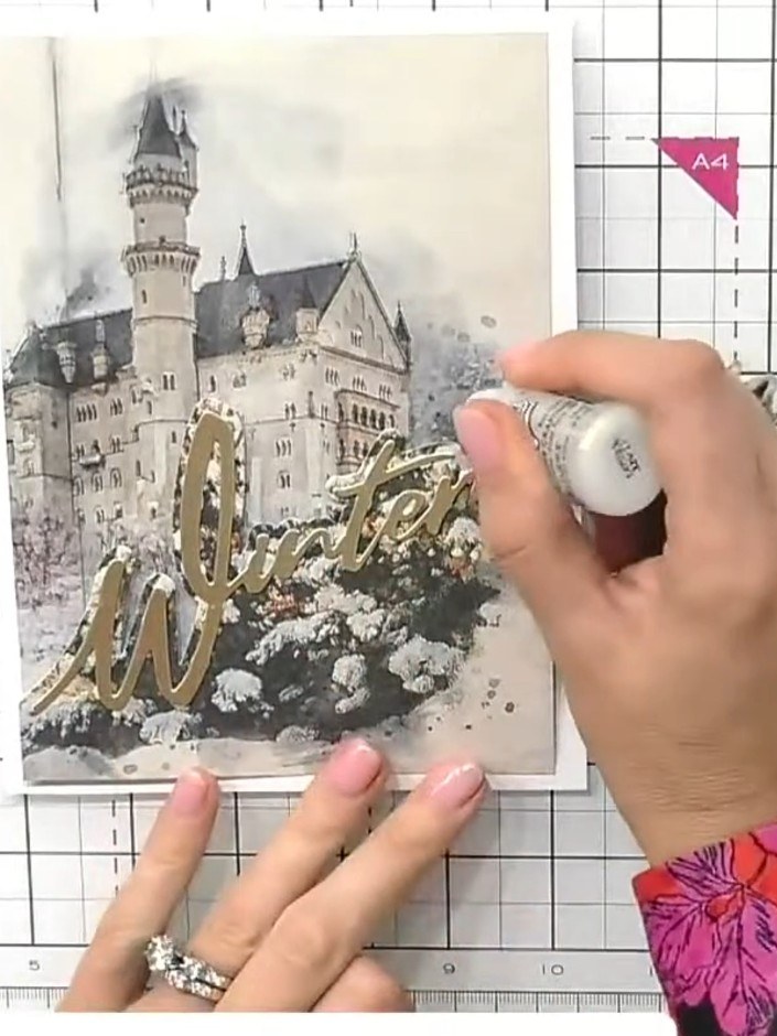 Step 8: Apply sparkle glue to the trees and background elements. Sprinkle glitter over the glued areas to create a sno