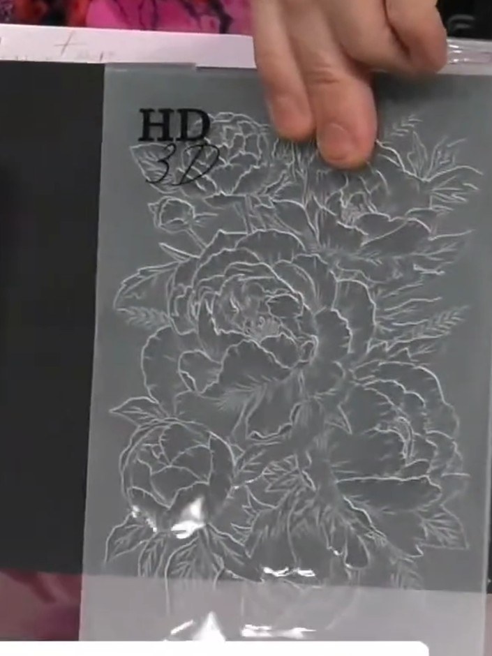 Step 5: Lightly brush white ink over the embossed design using a soft brush or sponge to highlight the raised details 