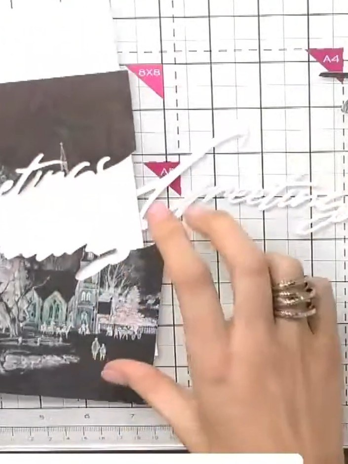 Step 7: Die cut the word 'Greetings' from white card stock using the Christmas Snow Drift Greetings die. Pop out the d
