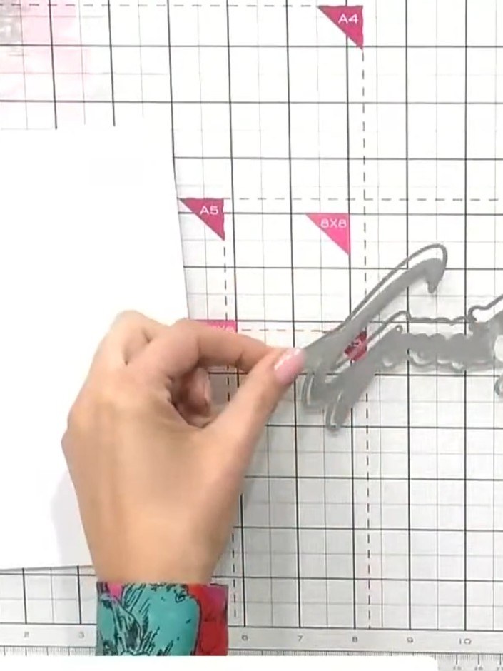 Step 1: Cut the snow drift word die (such as 'Greetings') from white card using your die-cutting machine.