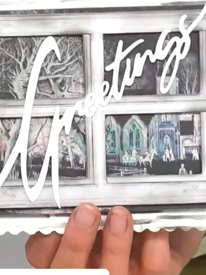 Step 7: Glue the white 'Joy' die-cut word across the top of the window frame, positioning it as a banner that overlaps