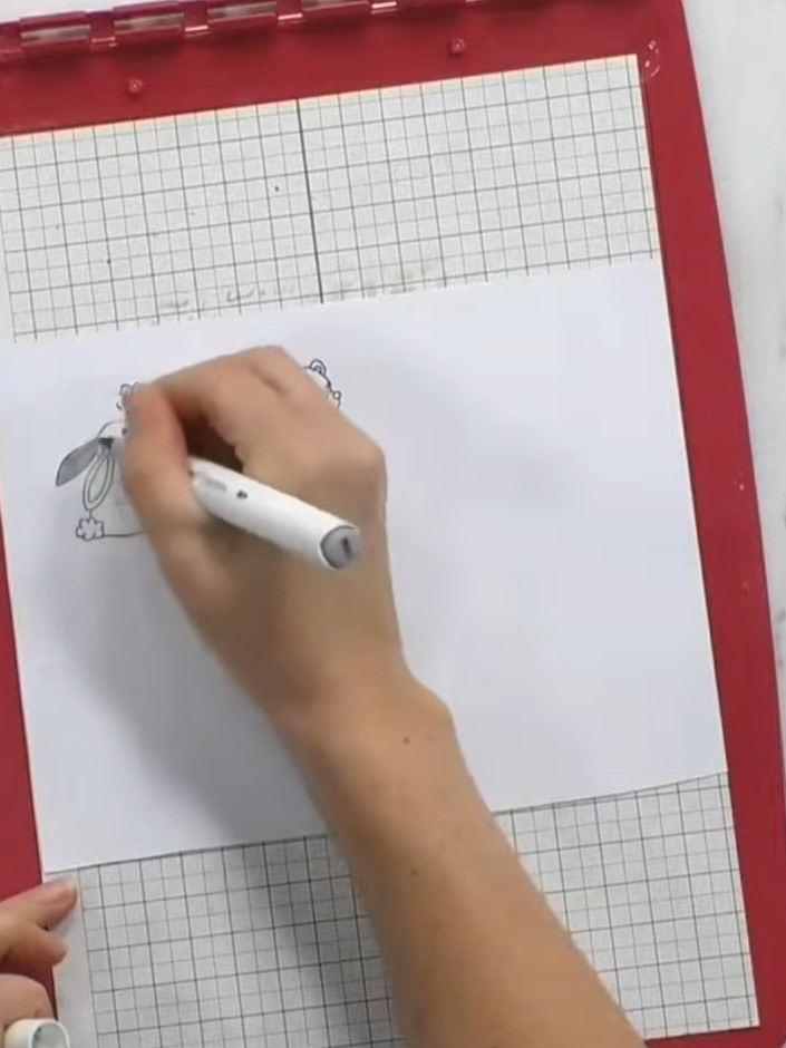 Step 2: Colour in the stamped animal using coloured pens, keeping the paper on the stencil platform for a flat surface