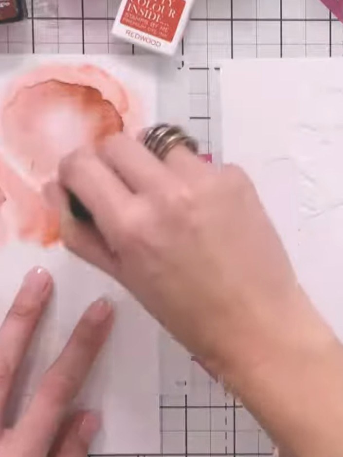 Step 5: Use a heat gun to thoroughly dry the sprayed ink on the card before applying the next stencil layer.