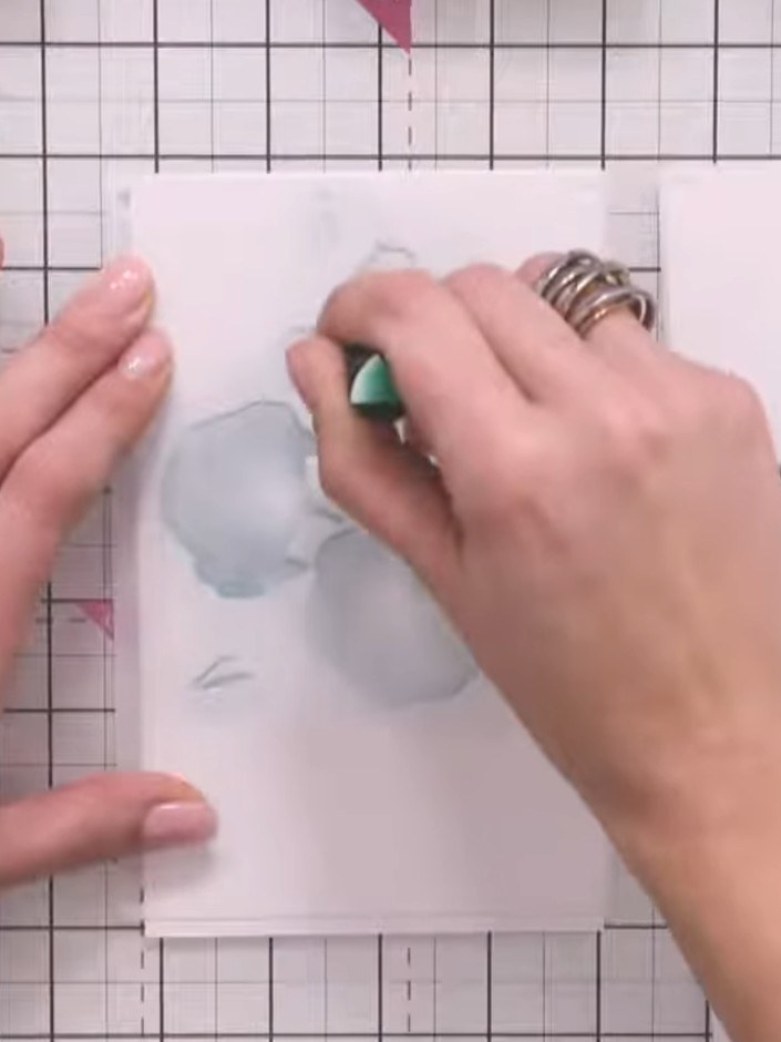 Step 7: Apply the fourth stencil layer using green ink to add the flower centres and sepals to your poppy design.