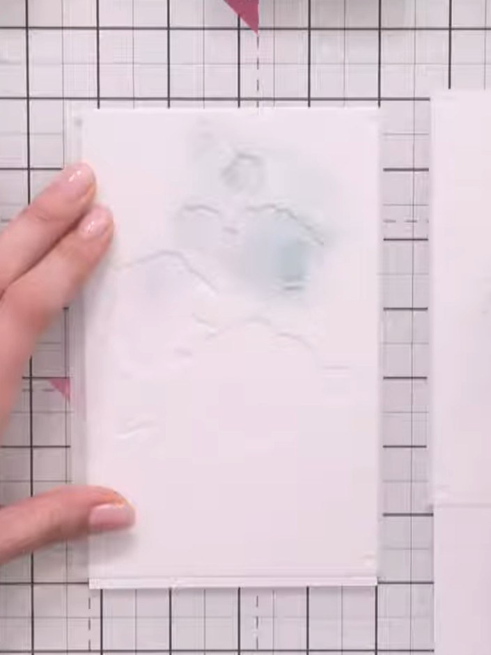 Step 1: Position the rose branch stencil on your white card base and secure it in place with magnets to hold it steady