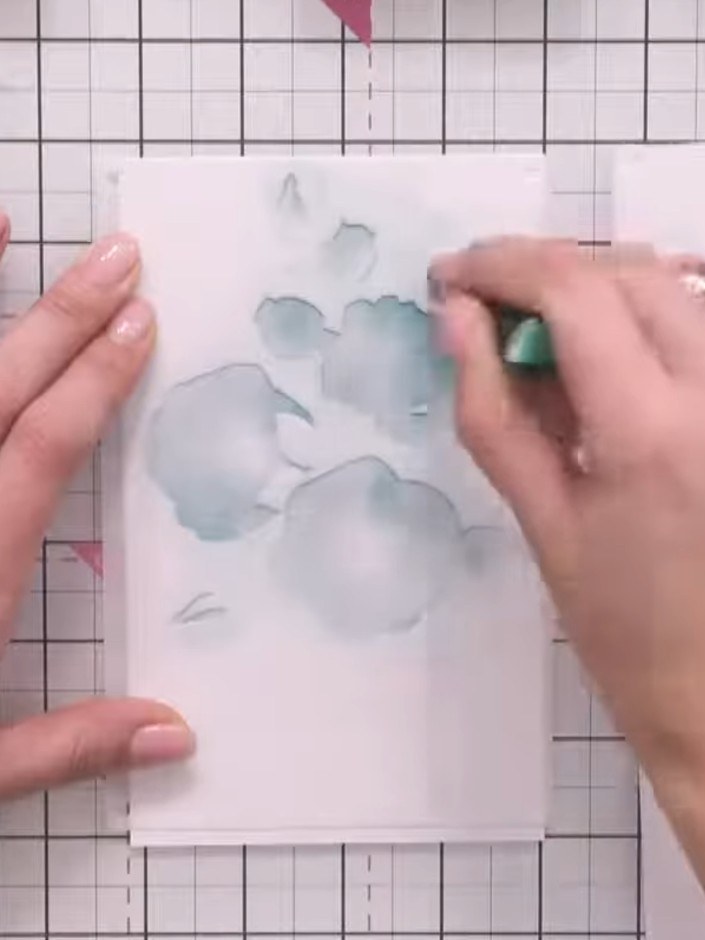 Step 3: Carefully remove the first stencil layer. Position the second layer of the rose branch stencil on your card, a