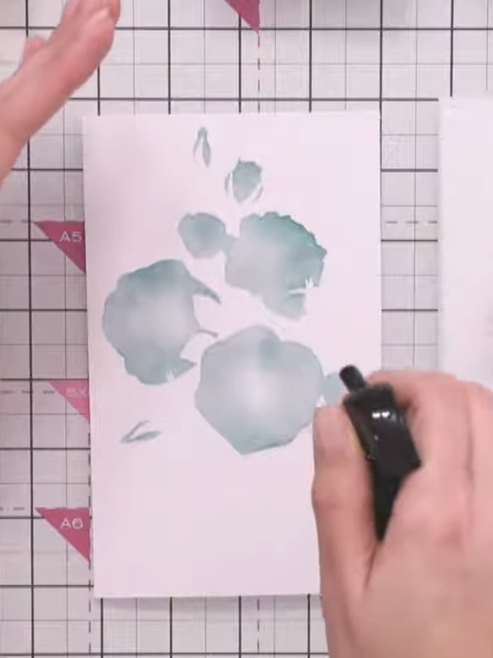 Step 4: Apply a darker teal ink through the second stencil layer, pressing lightly to avoid over-saturation. Use gentl