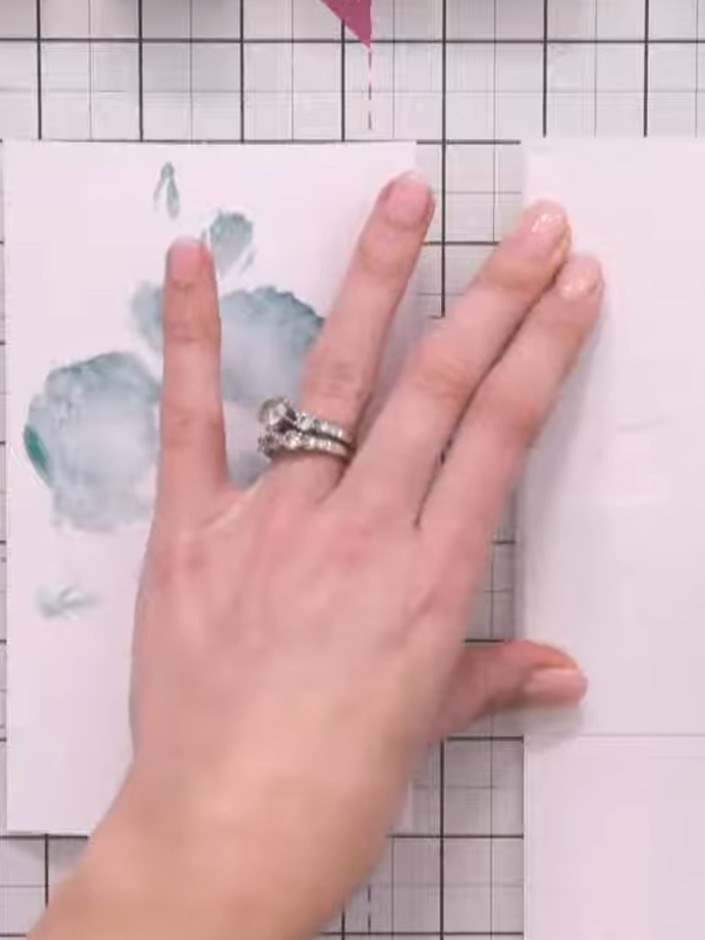 Step 1: Position the classic rose stencil on your white card and secure it in place using magnets to hold it steady du