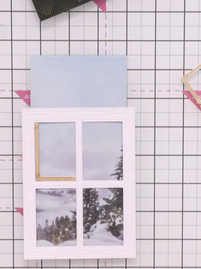 Step 7: Position the painted mount (with the grey winter scene images) behind the white window card frame. Align it so